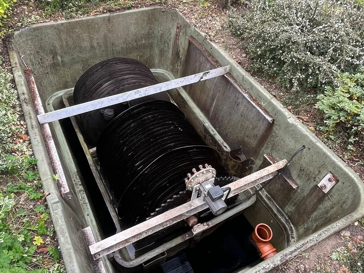 Rectangular treatment plant opened up with the biodisc and its shaft visible