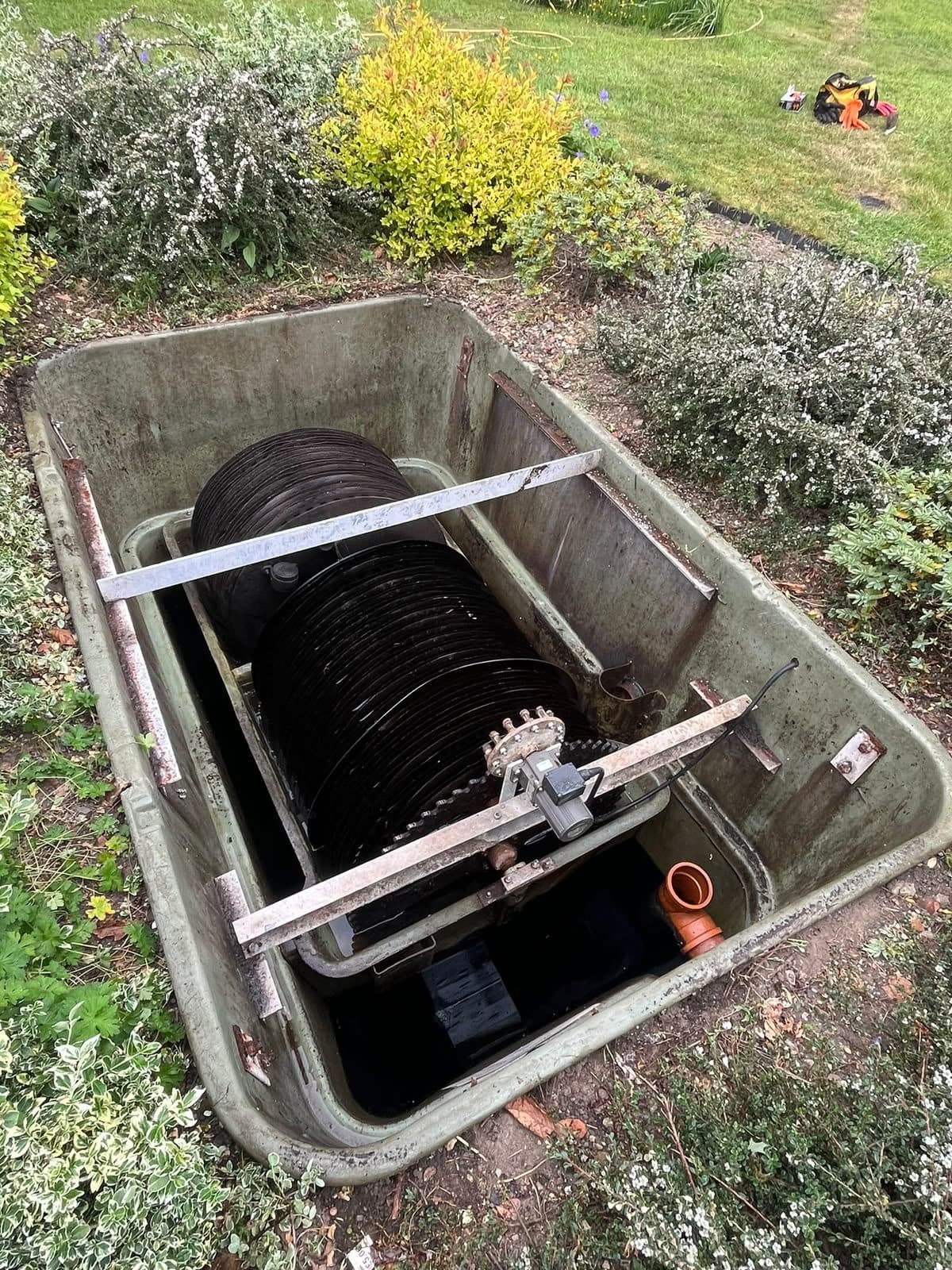 Rectangular treatment plant opened up with the biodisc and its shaft visible