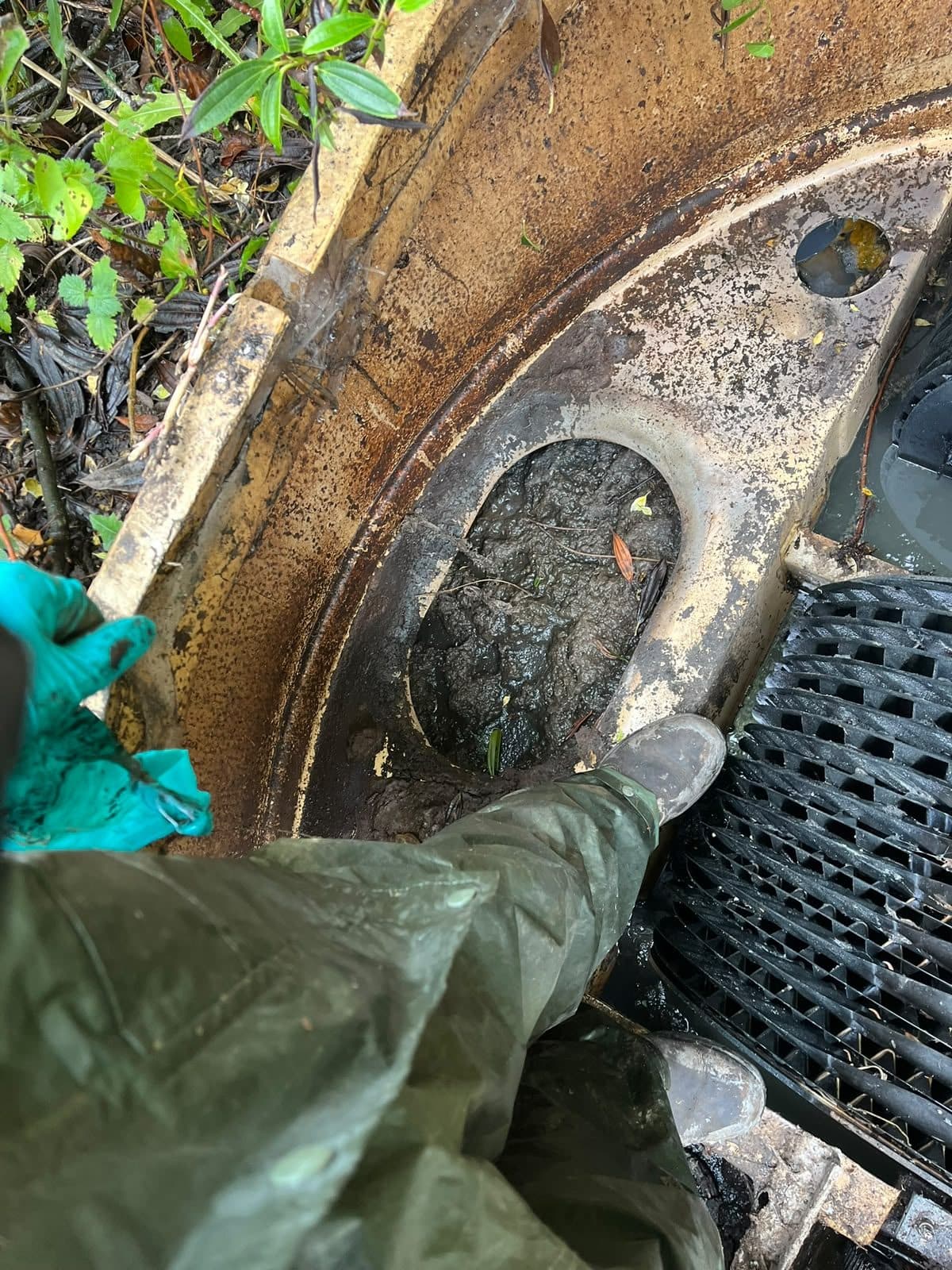 Engineer in gauntlets reaching into a chamber to clear it by hand