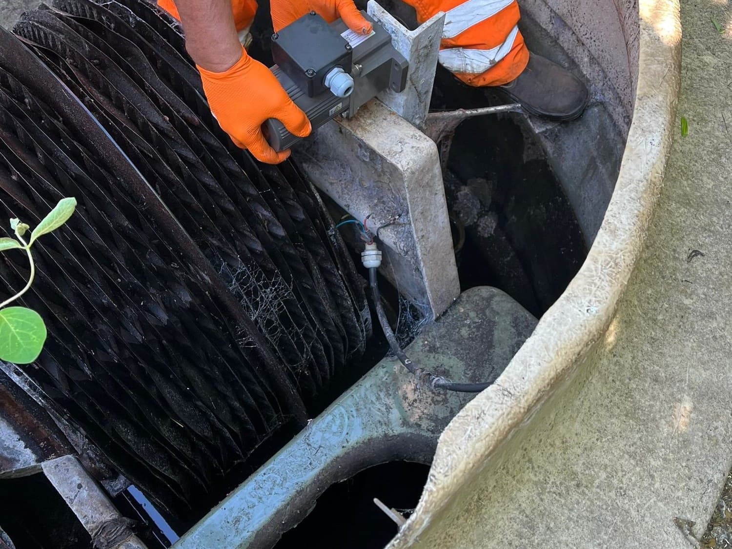 Close view of an engineer working on the biodisc assembly of a treatment plant