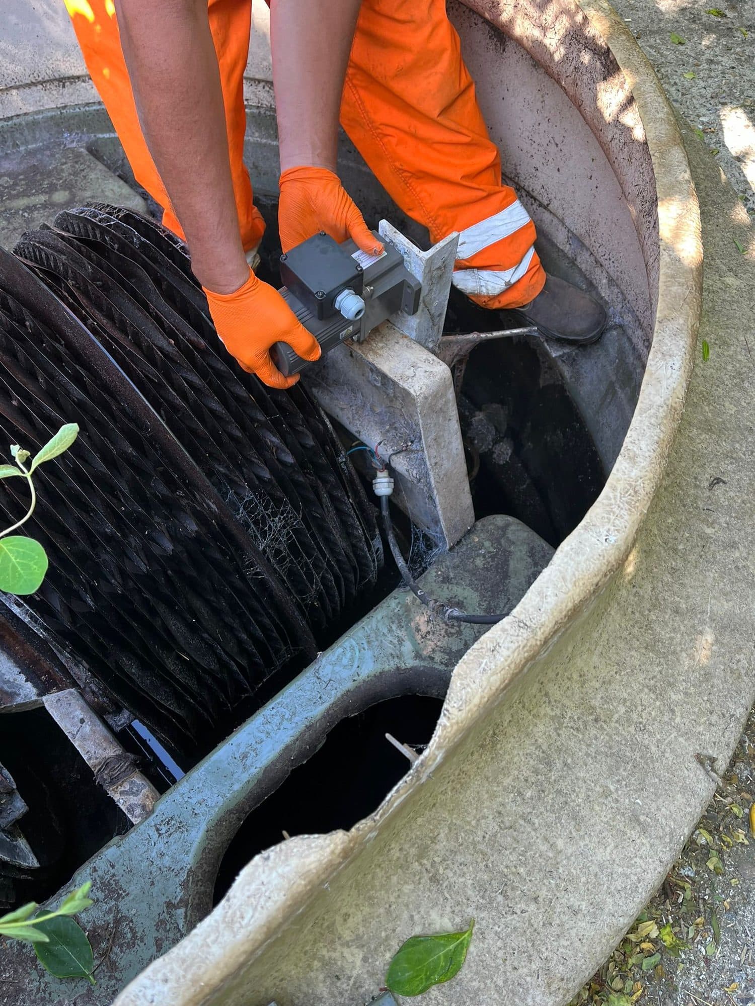 Close view of an engineer working on the biodisc assembly of a treatment plant