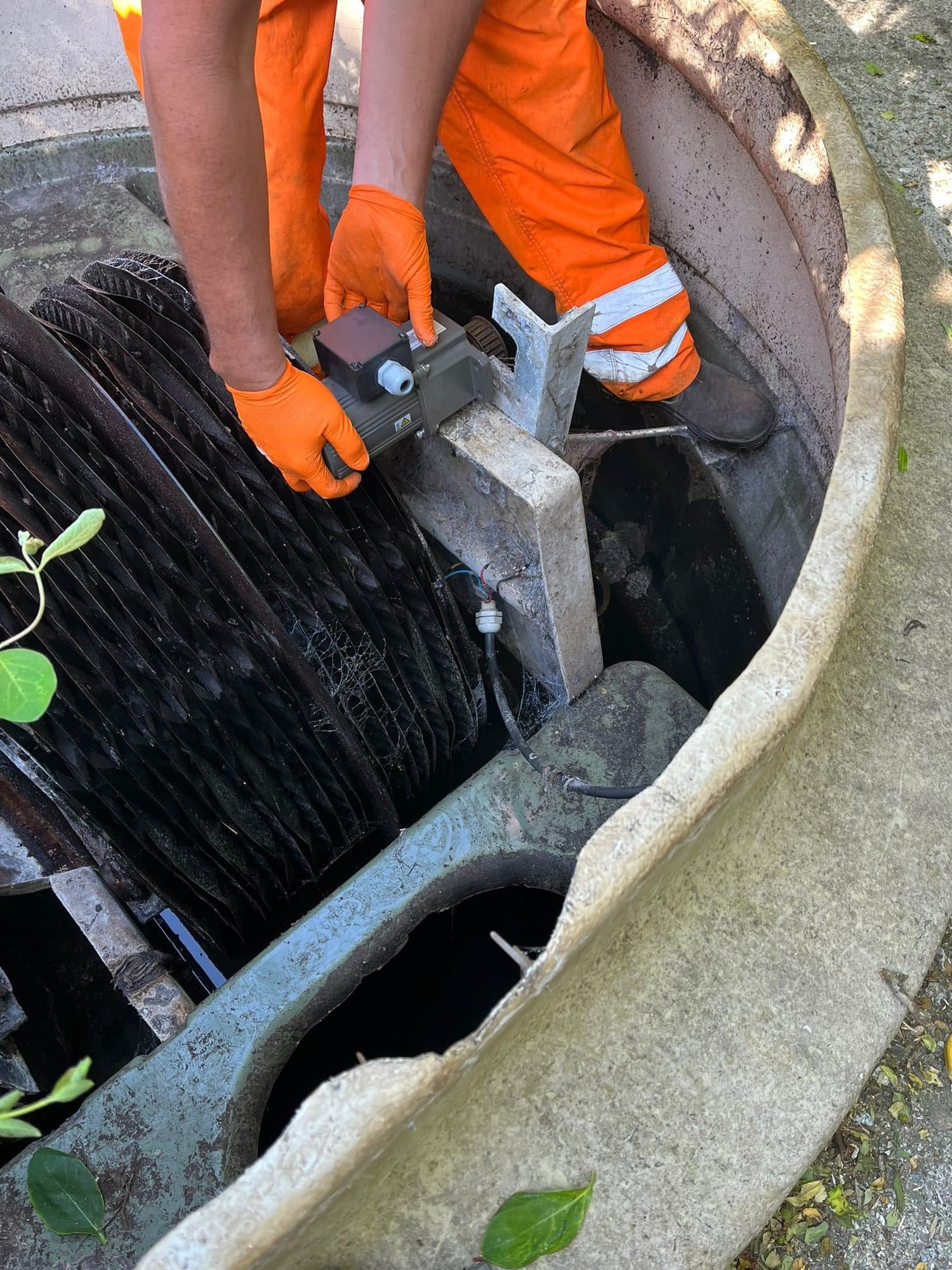 Engineer fitting a replacement bearing to the biodisc shaft of a sewage treatment plant