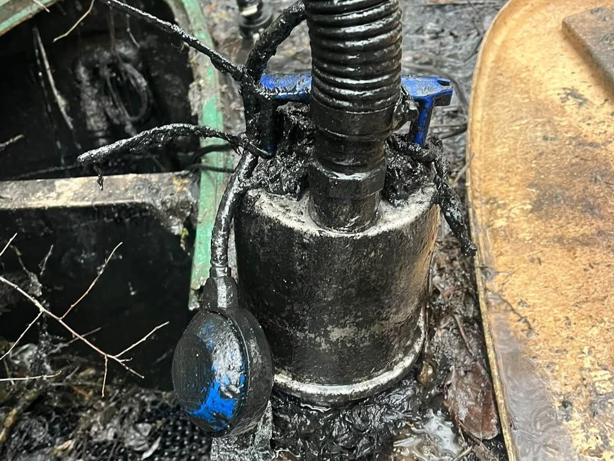 Pump and float switch down inside a wet well with the discharge hose connected
