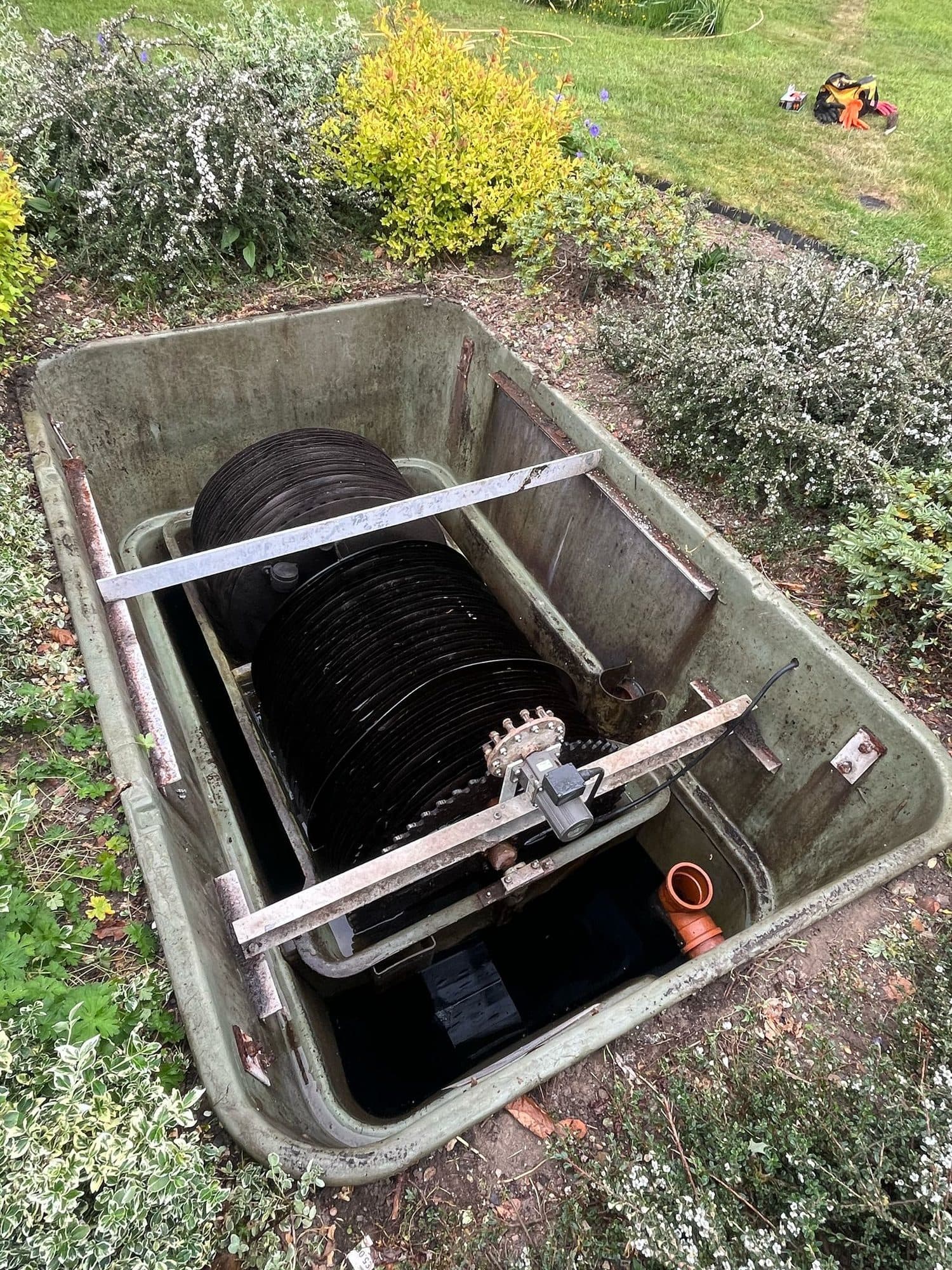 Rectangular treatment plant opened for servicing with the biodisc and drive motor visible